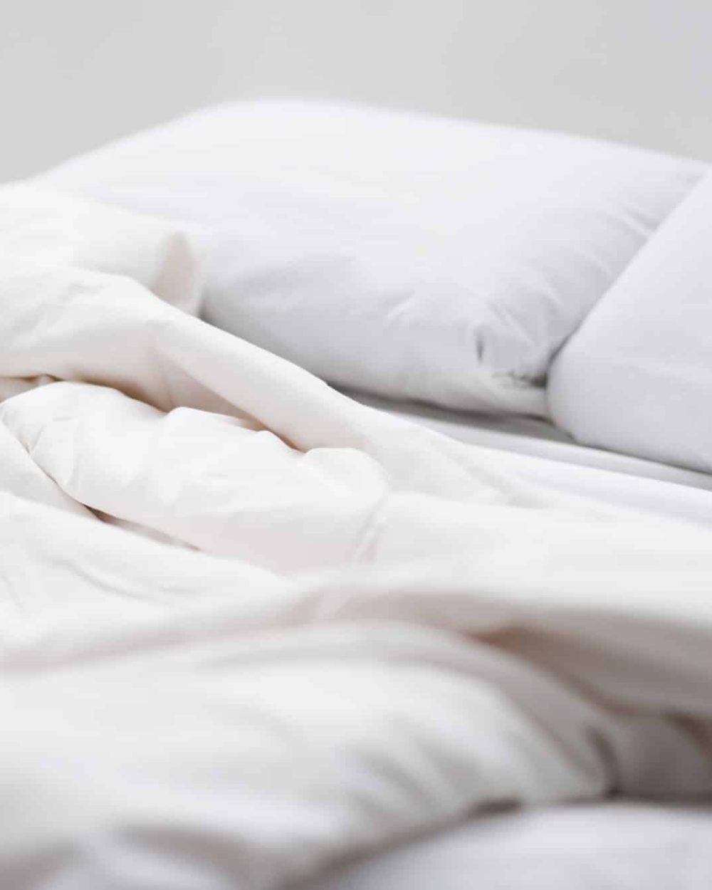 selective focus of bed with white pillows and blanket selective focus of bed with white pillows and blanket